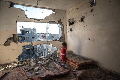 A Palestinian girl stands amid the rubble of her destroyed home in Beit Hanoun, Gaza.