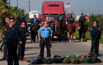 Occupy Houston protestors lay in the exit ramp of Loop 610 at the Port of Houston Authority Monday, Dec. 12, 2011, in Houston.