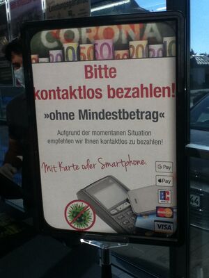 Sign in a German supermarket urging for "contactless" payment